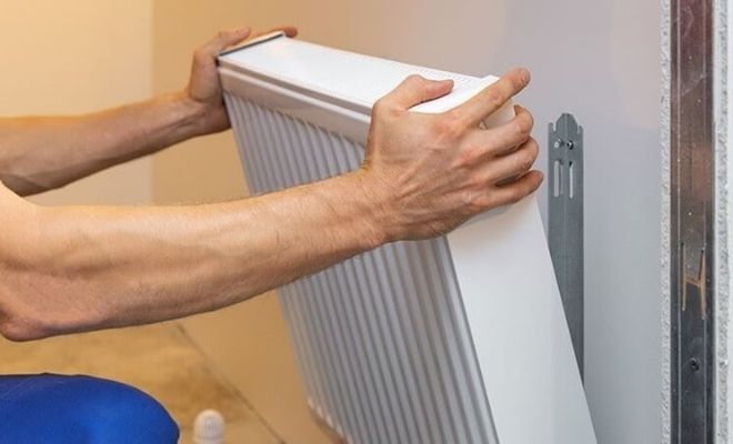 Man replacing a radiator