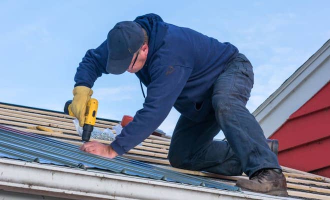 Tradesperson fixing roof