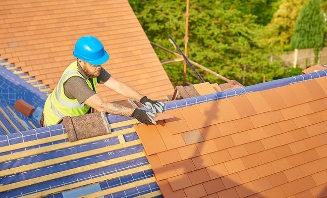 Man installing roof tiles