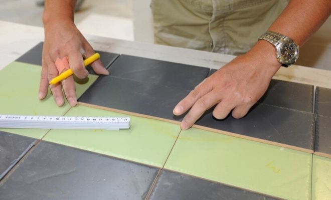 Tiler measuring tiles