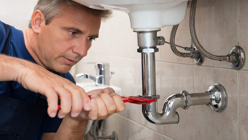 Plumber fixing a sink