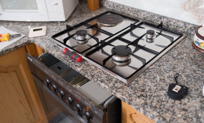 person installing gas cooker