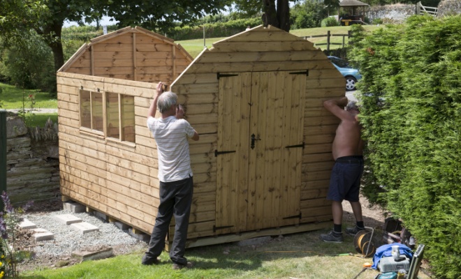 men removing shed