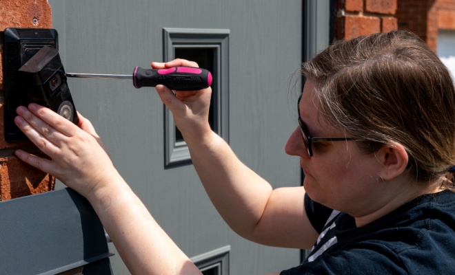 person installing ring doorbell