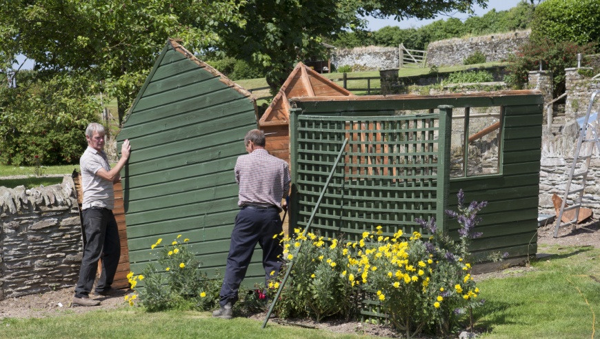 people removing shed