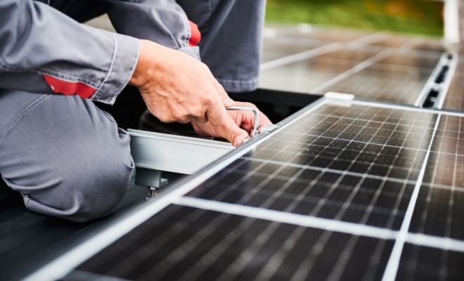 person installing solar panels